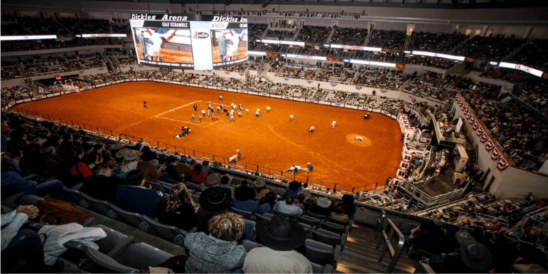 Indoor arena with dirt on the field