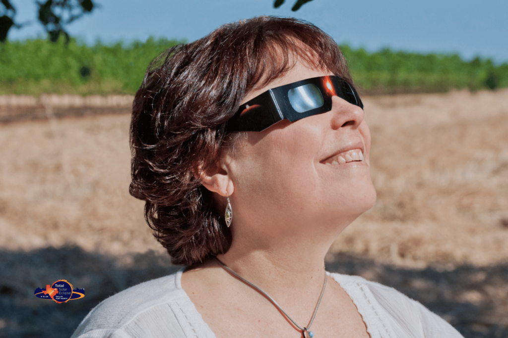 Woman wit solar eclipse glasses on
