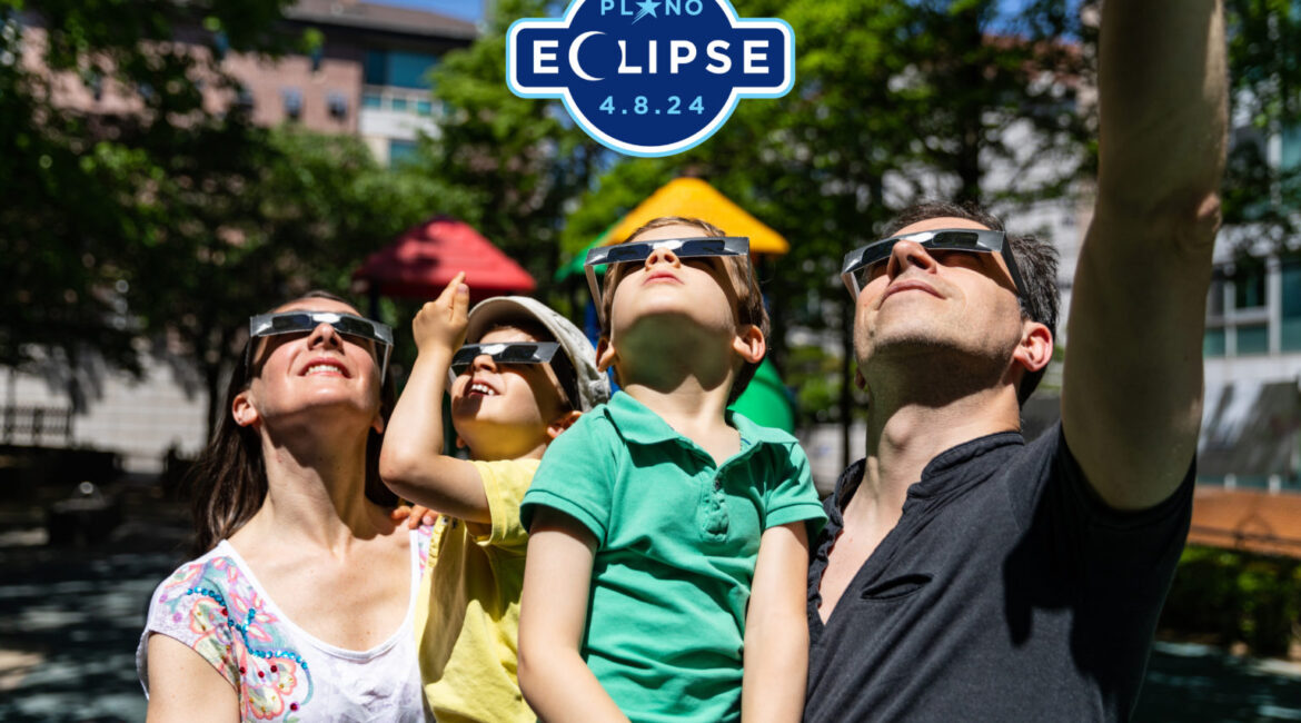 A family wearing glasses and looking up