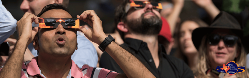 Close up of people with solar eclipse glasses on