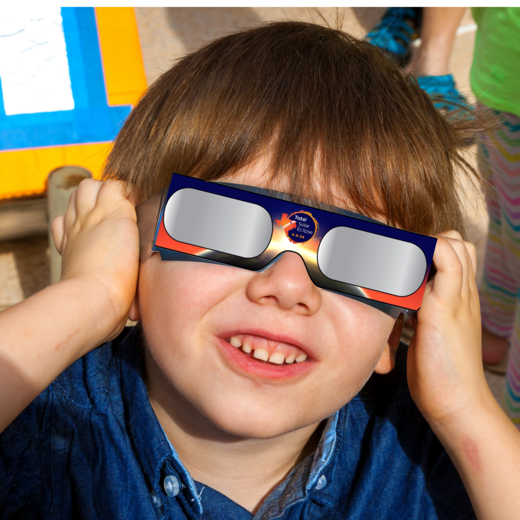 Boy with solar eclipse glasses on