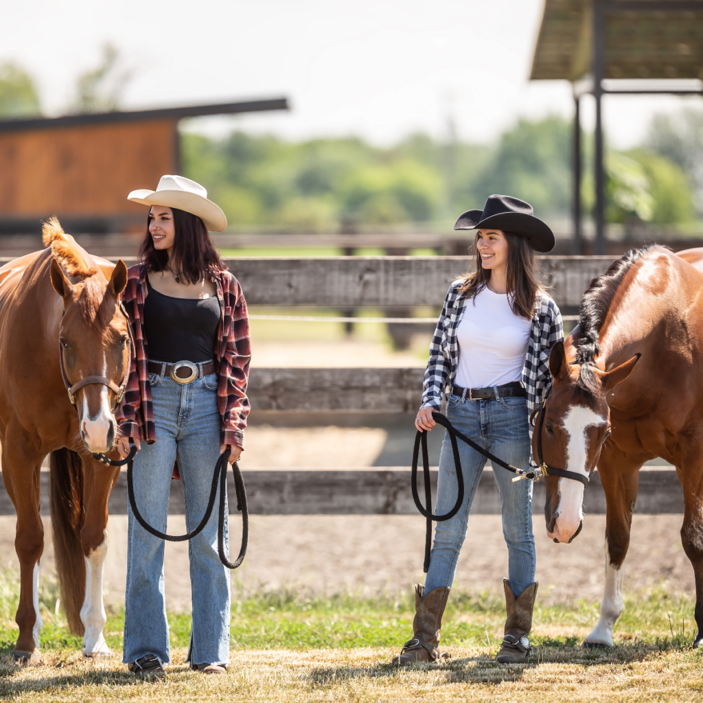 Two cowgirls with horses