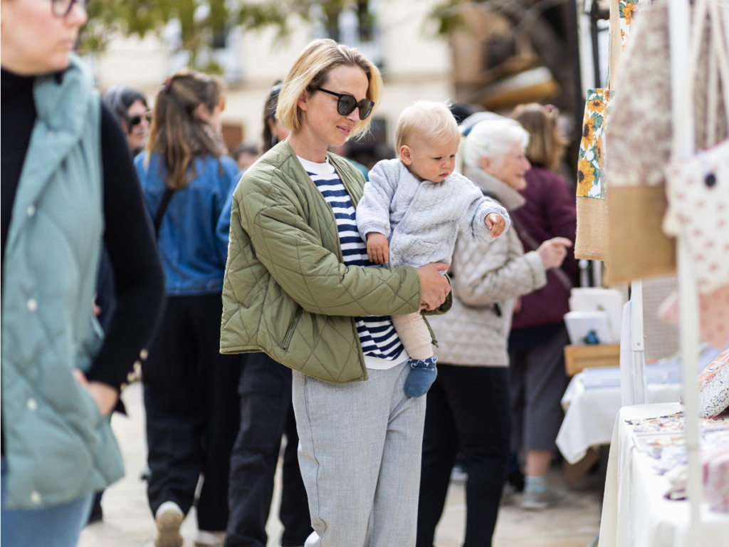 Mother and child shopping at an outdoor festival
