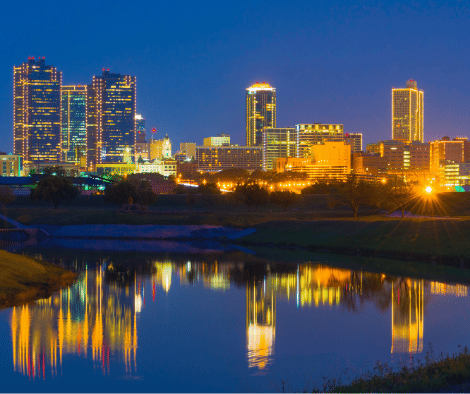 Fort Worth skyline at dusk with the Trinity River reflection