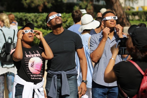 People outside wearing solar eclipse glasses. 